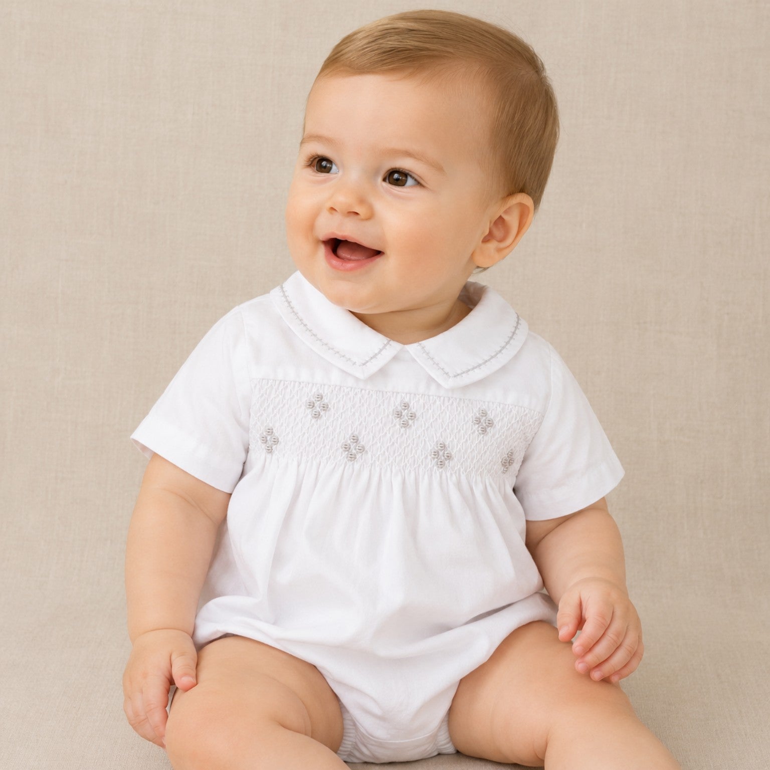 Bebé niño vistiendo bombacho de algodón blanco bordado a mano, ideal para bautizo y ceremonias.